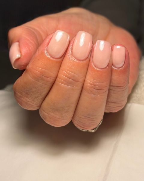 Glossy soft nude gel nails in a short square shape